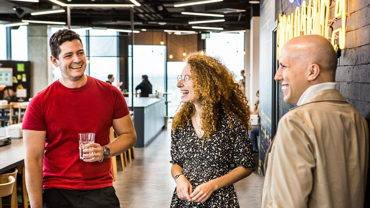 people chatting and sharing a joke at work